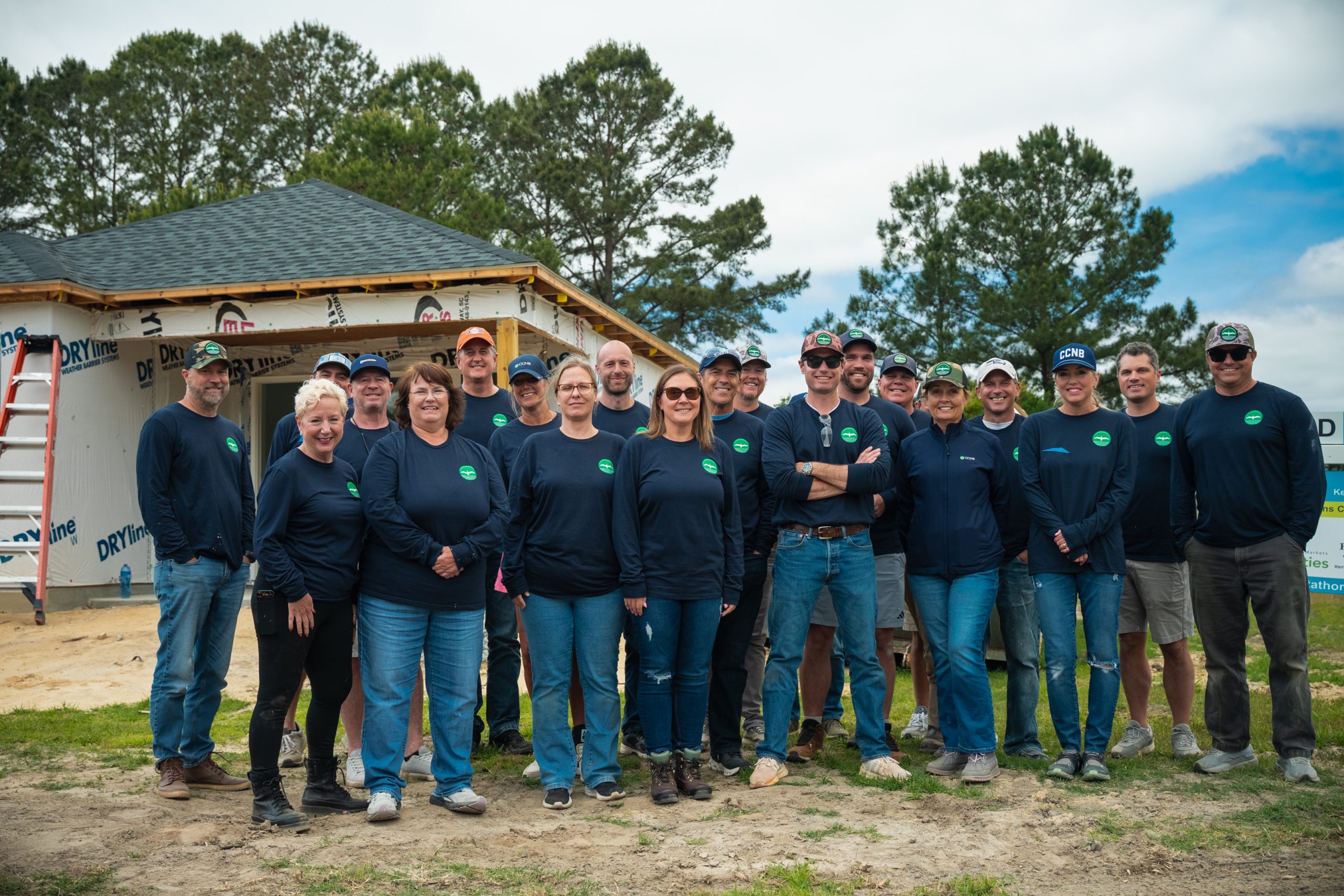A corporate volunteer team together at a Habitat build